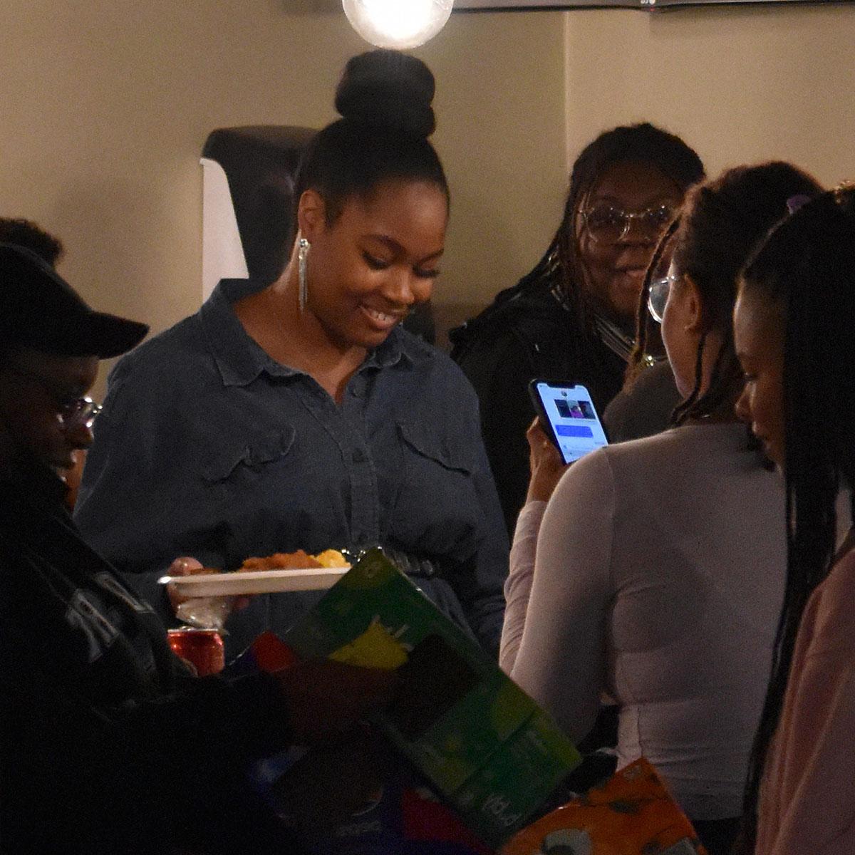 BIPOC students laughing and smiling with plates of food at BIPOC Family Dinner